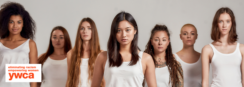 Diverse group of women standing in a line looking at the camera seriously